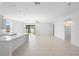 Open floor plan featuring a modern kitchen island and a view of the backyard through sliding glass doors at 417 Tisone Ln, Davenport, FL 33837