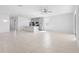 Bright, open-concept living room featuring tile flooring that seamlessly flows into the kitchen at 417 Tisone Ln, Davenport, FL 33837