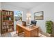 Functional home office with a wooden desk, bookcase, and a comfortable executive chair at 417 Tisone Ln, Davenport, FL 33837