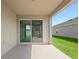 Covered patio with sliding glass doors offers an indoor/outdoor living experience and view of lawn at 417 Tisone Ln, Davenport, FL 33837