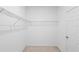 Walk-in closet featuring wire shelving and carpet flooring at 417 Tisone Ln, Davenport, FL 33837