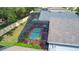 Aerial view of screened-in pool area, complete with patio furniture, safety fence, and lush landscaping at 4611 Cumbrian Lakes Dr, Kissimmee, FL 34746