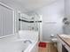 Bathroom featuring a soaking tub, separate glass shower, and double sink vanity with tile floors at 4611 Cumbrian Lakes Dr, Kissimmee, FL 34746