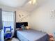 Cozy bedroom with a ceiling fan, window with blinds, and artwork on the wall at 4611 Cumbrian Lakes Dr, Kissimmee, FL 34746