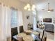 Open concept dining room next to sliding glass doors and view of the living room at 4611 Cumbrian Lakes Dr, Kissimmee, FL 34746