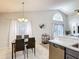 Dining room adjacent to kitchen shows vaulted ceilings and view of the outdoor space at 4611 Cumbrian Lakes Dr, Kissimmee, FL 34746