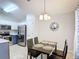 Cozy dining room adjacent to the kitchen, featuring black table and chairs and tile flooring at 4611 Cumbrian Lakes Dr, Kissimmee, FL 34746
