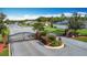 Gated entrance to a neighborhood featuring brick pillars, wrought iron gates, and mature landscaping at 4611 Cumbrian Lakes Dr, Kissimmee, FL 34746