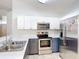 Modern kitchen with stainless steel appliances and gray and white cabinets at 4611 Cumbrian Lakes Dr, Kissimmee, FL 34746