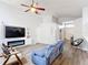 Bright living room with a fireplace, ceiling fan, and modern decor at 4611 Cumbrian Lakes Dr, Kissimmee, FL 34746