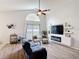 Bright living room featuring high ceilings, modern furnishings, and a view of the backyard at 4611 Cumbrian Lakes Dr, Kissimmee, FL 34746