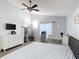 Bright main bedroom featuring a ceiling fan, dresser, crib and window with a sheer curtain at 4611 Cumbrian Lakes Dr, Kissimmee, FL 34746