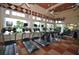 Bright gym featuring modern treadmills and exercise equipment with large windows and a view to the pool at 4850 Waltham Forest Dr, Davenport, FL 33837