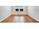 Bright empty bedroom with hardwood flooring, neutral paint, and large window allowing ample natural light at 491 Whistling Duck Trl, St Cloud, FL 34771