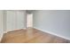 A bedroom featuring light gray walls and wood flooring, offering a serene and modern aesthetic at 491 Whistling Duck Trl, St Cloud, FL 34771