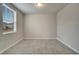 A bright empty bedroom with tile flooring with large window allowing ample natural light at 491 Whistling Duck Trl, St Cloud, FL 34771