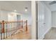 Hallway featuring wood flooring and a staircase with a modern iron railing at 491 Whistling Duck Trl, St Cloud, FL 34771