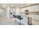 Modern kitchen featuring stainless steel appliances, granite countertops, and a spacious island with breakfast bar seating at 491 Whistling Duck Trl, St Cloud, FL 34771