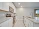 Contemporary kitchen featuring stainless steel appliances and granite countertops with white cabinetry at 491 Whistling Duck Trl, St Cloud, FL 34771