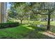 Lush backyard featuring a tranquil pond and mature trees at 500 Mirasol Cir # 203, Celebration, FL 34747