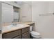 Bathroom featuring a washer-dryer combo unit, a large mirror, and a sleek countertop at 500 Mirasol Cir # 203, Celebration, FL 34747