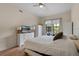 Spacious bedroom featuring wood floors, ceiling fan and a large window with mature landscaping at 500 Mirasol Cir # 203, Celebration, FL 34747