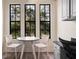 Cozy breakfast nook with large windows, white round table, and comfortable seating at 500 Mirasol Cir # 203, Celebration, FL 34747