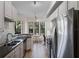 Modern kitchen with stainless steel appliances, stylish tile backsplash and a bright breakfast nook at 500 Mirasol Cir # 203, Celebration, FL 34747