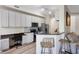 Well-appointed kitchen with an adjacent workspace, breakfast bar, stainless steel appliances, and modern cabinetry at 500 Mirasol Cir # 203, Celebration, FL 34747