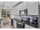 Well-equipped kitchen featuring stainless steel appliances, light cabinetry, and a dining area with natural light at 500 Mirasol Cir # 203, Celebration, FL 34747