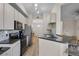 Open-concept kitchen with bar seating, stainless steel appliances, and stylish finishes at 500 Mirasol Cir # 203, Celebration, FL 34747