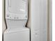 A stacked washer-dryer unit is situated near a closet with access to mechanicals at 500 Mirasol Cir # 203, Celebration, FL 34747