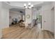 Spacious living room with hardwood floors, stylish lighting, and an adjacent office and kitchen area at 500 Mirasol Cir # 203, Celebration, FL 34747