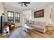 Comfortable living room showcasing wood flooring, modern furnishings, and abundant natural light at 500 Mirasol Cir # 203, Celebration, FL 34747