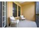 Relaxing covered patio seating area featuring two chairs and small table at 500 Mirasol Cir # 203, Celebration, FL 34747