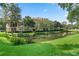 Beautiful building overlooking a pond, surrounded by lush greenery, offering a tranquil setting at 500 Mirasol Cir # 203, Celebration, FL 34747