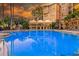 Resort-style pool area with cabanas and lush landscaping, perfect for relaxation and entertainment at 500 Mirasol Cir # 203, Celebration, FL 34747