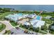 Aerial view showcasing the community clubhouse, pools, and surrounding landscape by the lake at 5081 Twin Lakes Blvd, St Cloud, FL 34772