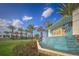 Welcoming 'Twin Lakes' community sign surrounded by palm trees, vibrant flowers and a water feature at 5081 Twin Lakes Blvd, St Cloud, FL 34772
