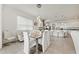 Stylish dining area with modern chandelier and view into kitchen with white cabinetry at 5081 Twin Lakes Blvd, St Cloud, FL 34772