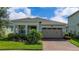 Charming single-story home with a well-manicured lawn and a welcoming two-car garage, fronted by a brick driveway at 5081 Twin Lakes Blvd, St Cloud, FL 34772