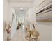 Well-lit hallway with neutral décor, showcasing an art collection and leading into the open living space at 5081 Twin Lakes Blvd, St Cloud, FL 34772