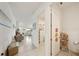 Bright hallway with neutral tile flooring leading into a spacious open-concept living area with natural light at 5081 Twin Lakes Blvd, St Cloud, FL 34772