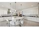 Bright, open kitchen featuring a large center island with bar seating, surrounded by white cabinets and stainless steel appliances at 5081 Twin Lakes Blvd, St Cloud, FL 34772