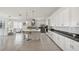 Modern kitchen featuring white cabinets, stainless steel appliances, and a central island with seating at 5081 Twin Lakes Blvd, St Cloud, FL 34772