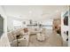 Expansive open-concept living area with a white leather sectional sofa and kitchen with stainless appliances at 5081 Twin Lakes Blvd, St Cloud, FL 34772