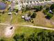 Aerial view of property featuring a house, adjacent land, and community pond at 5365 Rambling Rd, St Cloud, FL 34771