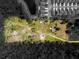 An aerial view of a spacious property with ample land, located near a serene lake and modern homes at 5365 Rambling Rd, St Cloud, FL 34771