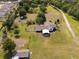 Aerial view of large property with home, shed, and a drive-through carport at 5365 Rambling Rd, St Cloud, FL 34771