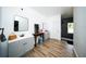 Modern bathroom featuring sleek wood flooring, double sink vanity, contemporary mirrors and a tiled shower at 5365 Rambling Rd, St Cloud, FL 34771